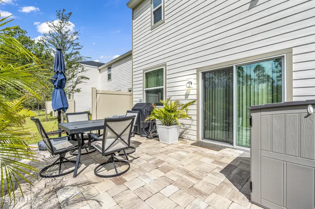 a view of a chairs and table in patio