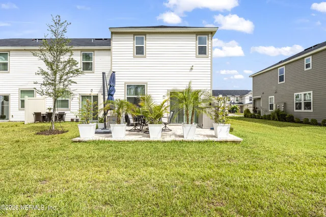 a view of a house with swimming pool and sitting area