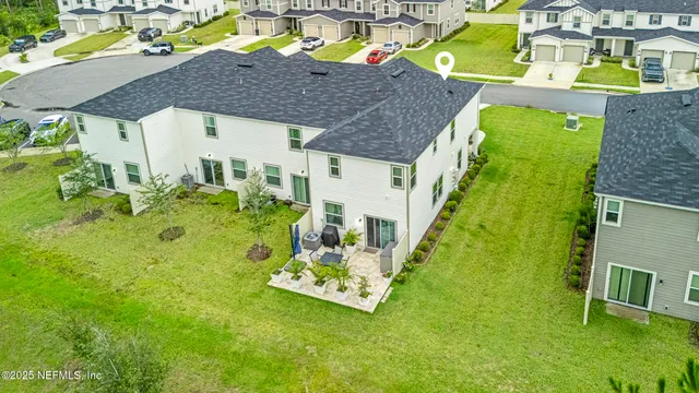 a aerial view of a house with a yard