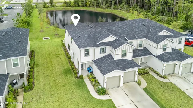 an aerial view of a house with a yard
