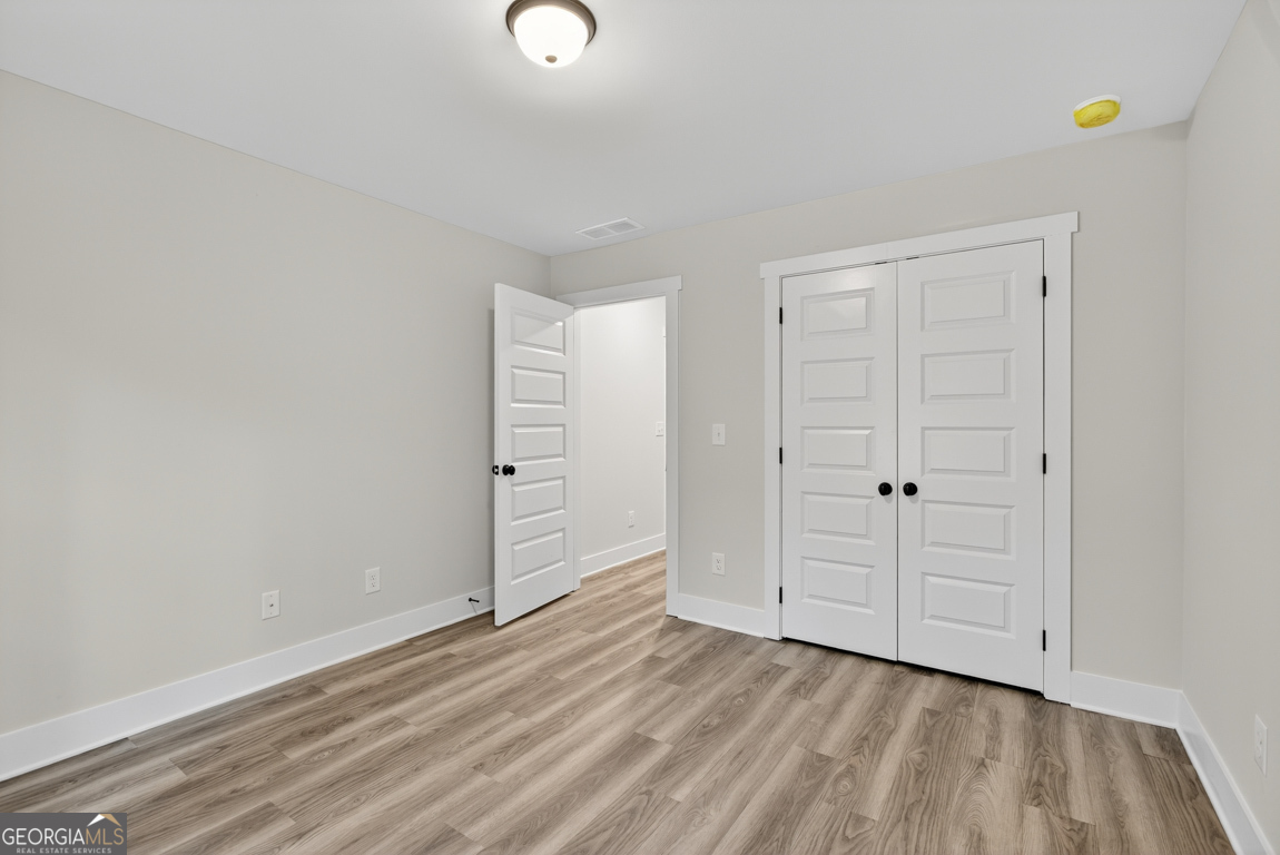 88 Mockingbird Lane, Unit 37 Winder, GA 30680 - Photo 13 of 40 a view of empty room with wooden floor