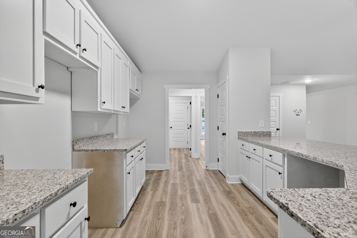 88 Mockingbird Lane, Unit 37 Winder, GA 30680 - Photo 24 of 40 a kitchen with granite countertop a sink stove and refrigerator