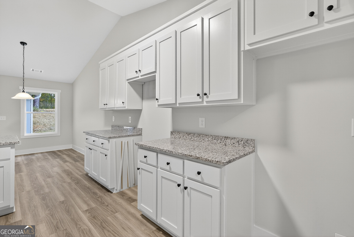 88 Mockingbird Lane, Unit 37 Winder, GA 30680 - Photo 27 of 40 a kitchen with white cabinets and sink