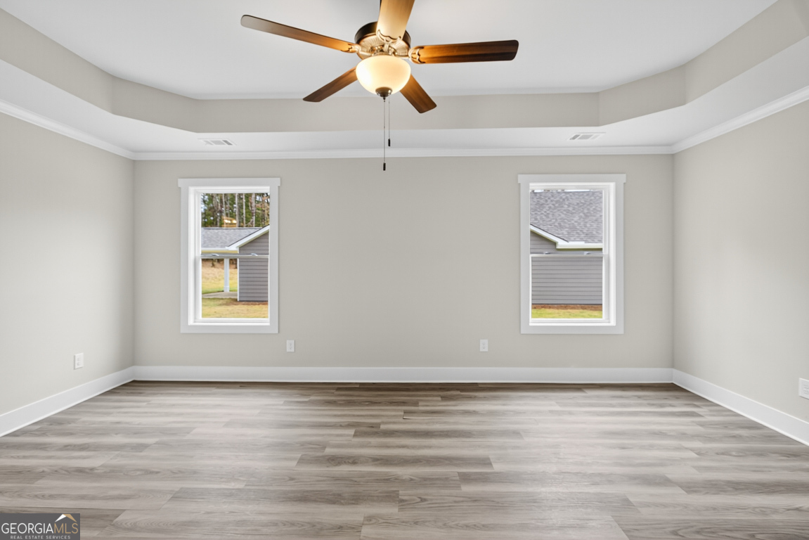 88 Mockingbird Lane, Unit 37 Winder, GA 30680 - Photo 28 of 40 a view of an empty room with a window and wooden floor