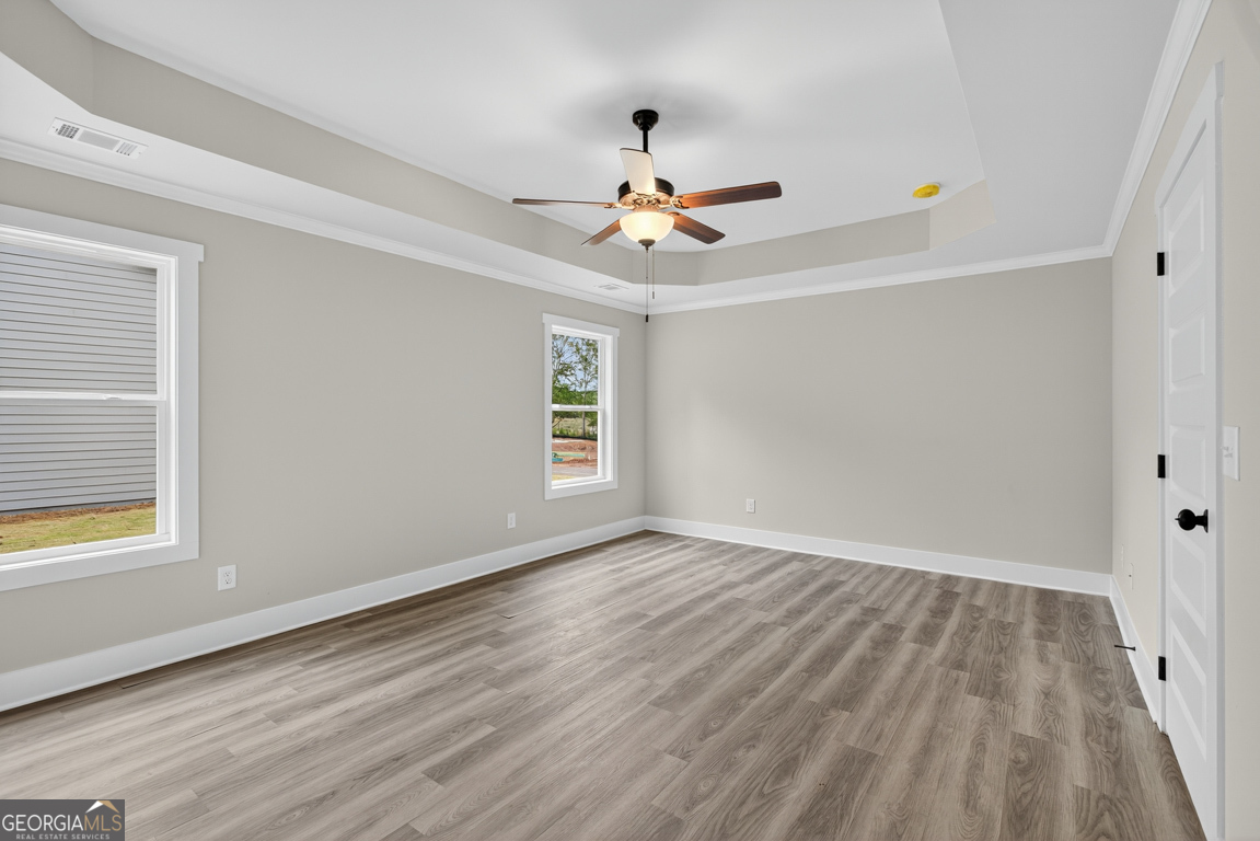 88 Mockingbird Lane, Unit 37 Winder, GA 30680 - Photo 29 of 40 wooden floor in an empty room with a window