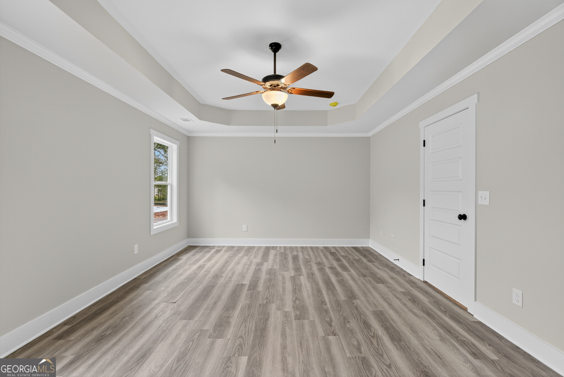 88 Mockingbird Lane, Unit 37 Winder, GA 30680 - Photo 30 of 40 wooden floor in an empty room with a window