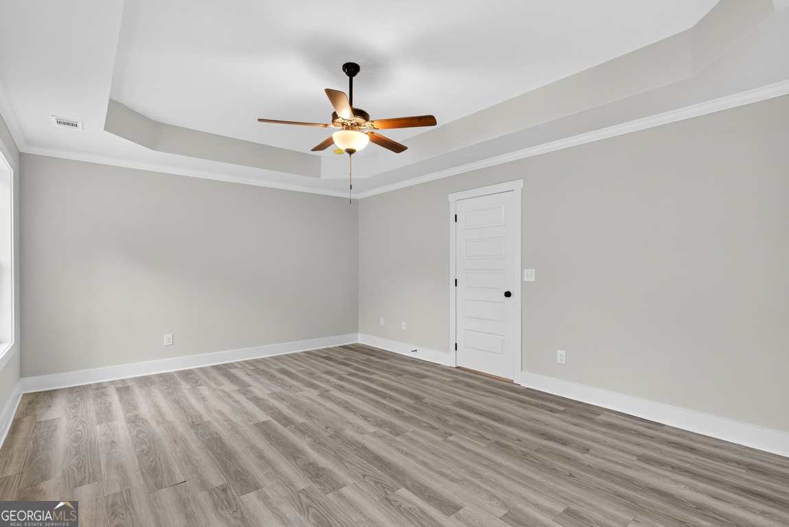 88 Mockingbird Lane, Unit 37 Winder, GA 30680 - Photo 31 of 40 a view of a room with wooden floor and ceiling fan