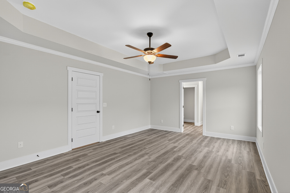 88 Mockingbird Lane, Unit 37 Winder, GA 30680 - Photo 32 of 40 wooden floor in an empty room with a window