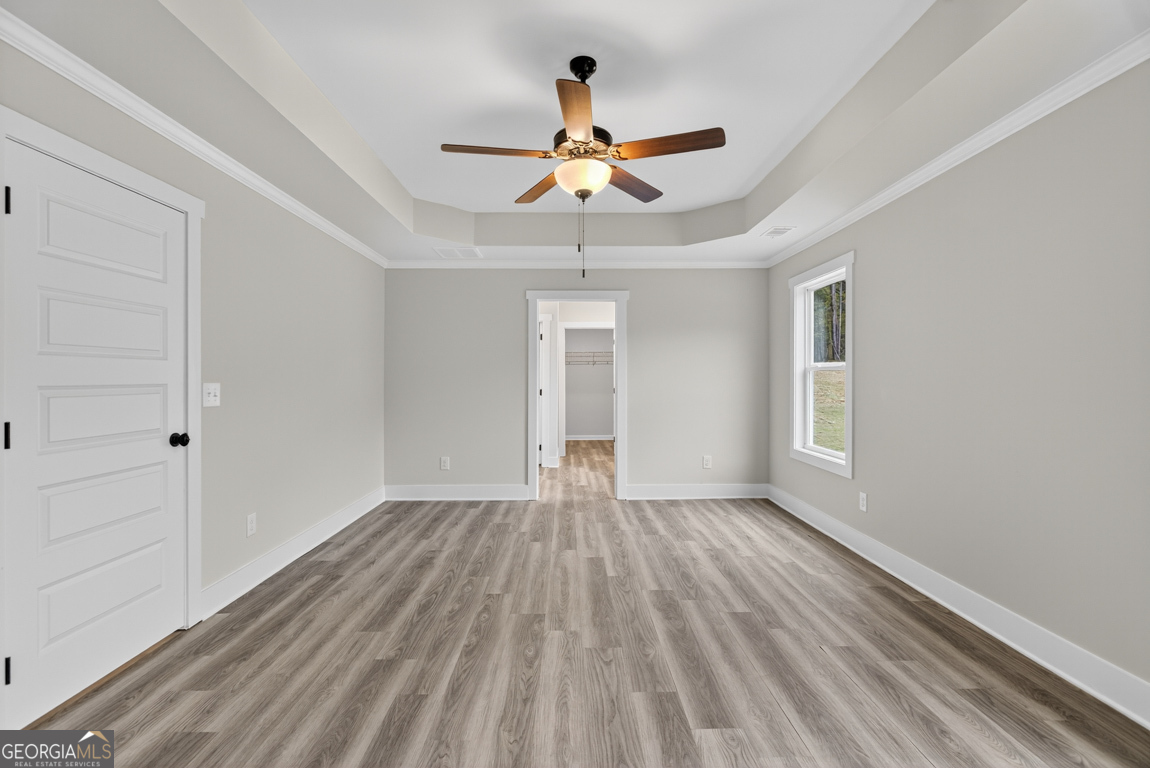 88 Mockingbird Lane, Unit 37 Winder, GA 30680 - Photo 33 of 40 a view of empty room with wooden floor and fan