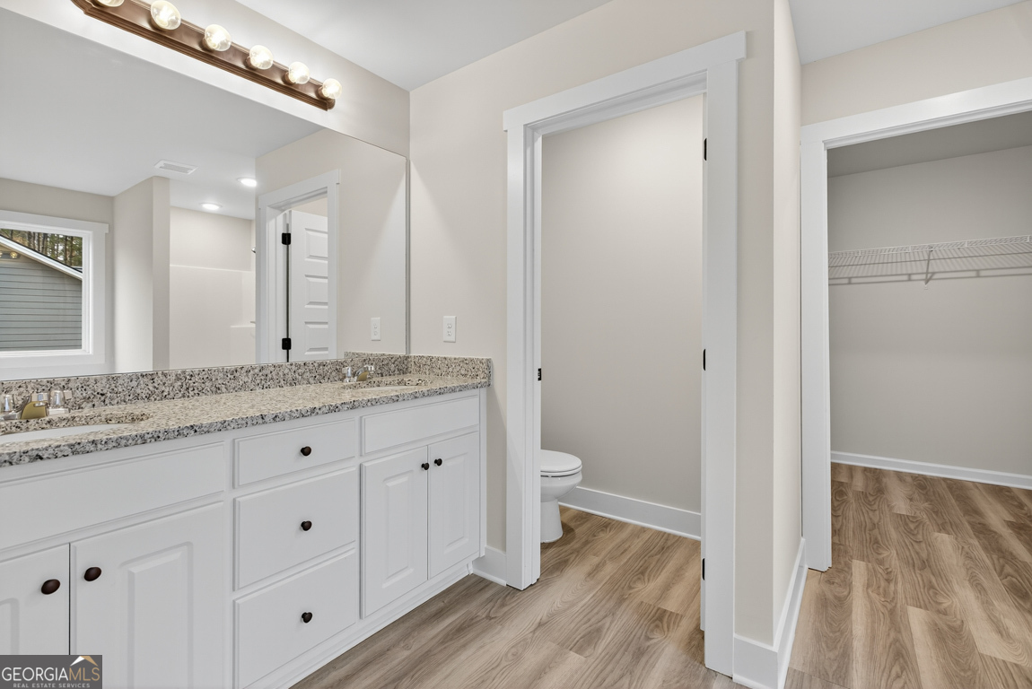 88 Mockingbird Lane, Unit 37 Winder, GA 30680 - Photo 34 of 40 a bathroom with a granite countertop sink toilet and shower