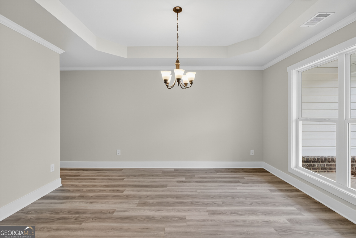 88 Mockingbird Lane, Unit 37 Winder, GA 30680 - Photo 4 of 40 a view of a room with wooden floor and a window