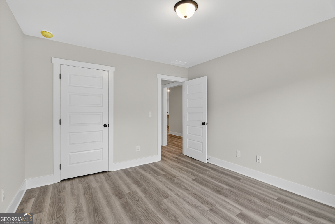 88 Mockingbird Lane, Unit 37 Winder, GA 30680 - Photo 8 of 40 a view of an empty room and wooden floor