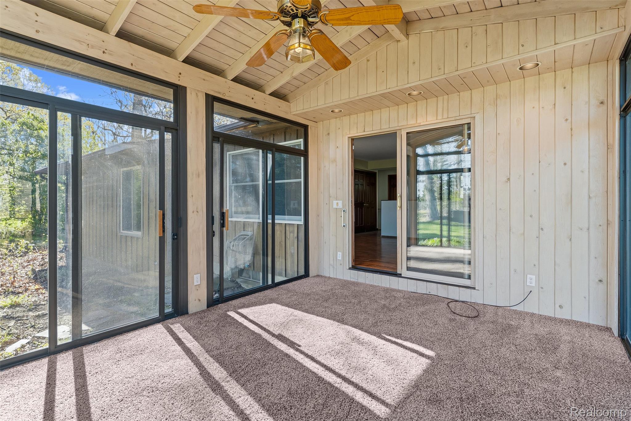 4191 McCandlish Road Grand Blanc, MI 48439 - Photo 17 of 53 Unfurnished sunroom featuring a ceiling fan and beamed ceiling and 6 sliding glass doors