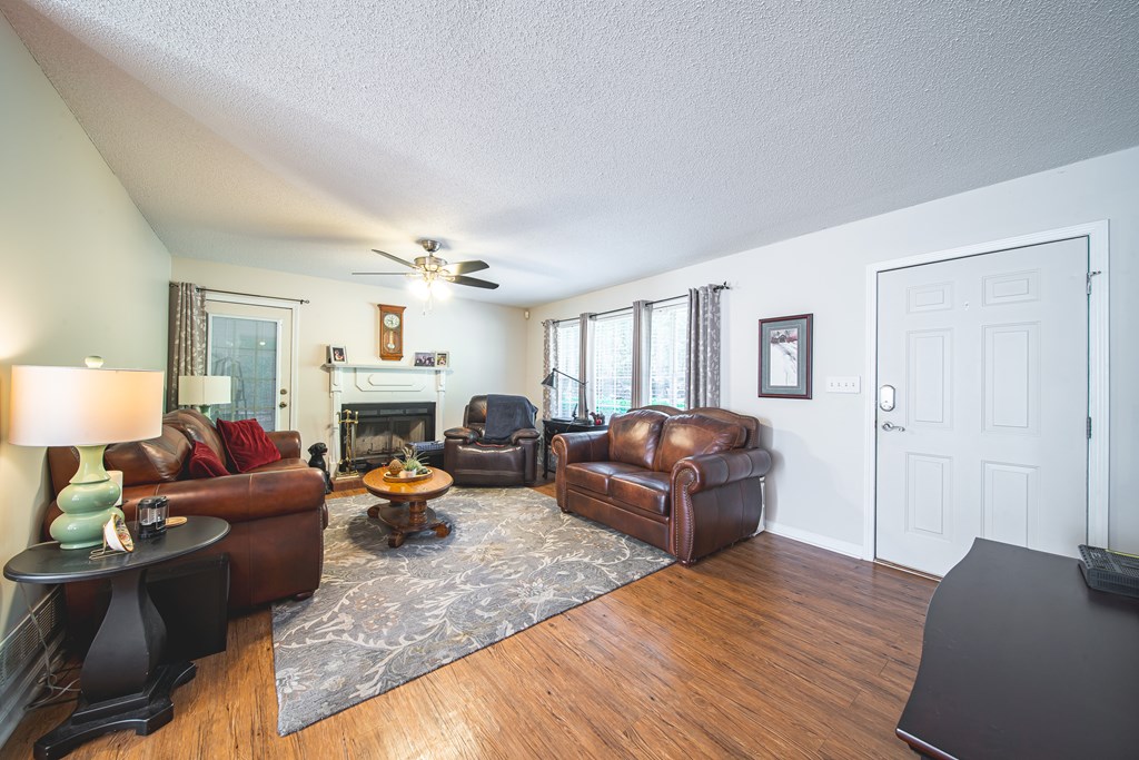 200 Lake Amah Lee Road Hampton, GA 30228 - Photo 6 of 29 a living room with furniture a fireplace and a chandelier