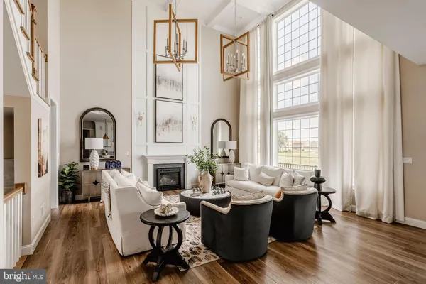 a living room with fireplace furniture and a large window
