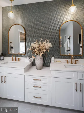 a bathroom with a sink mirror and