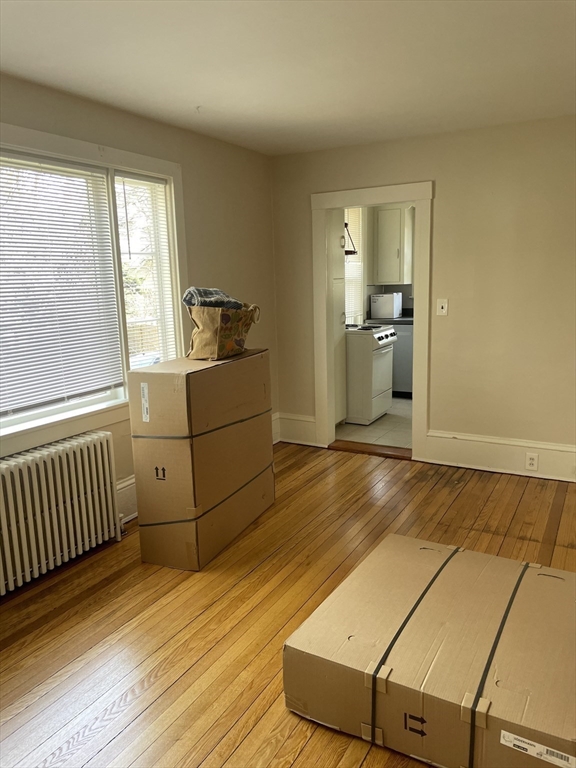 15 Harris Street, Unit 2 Marblehead, MA 01945 - Photo 11 of 19 a room with a bed and wooden floor
