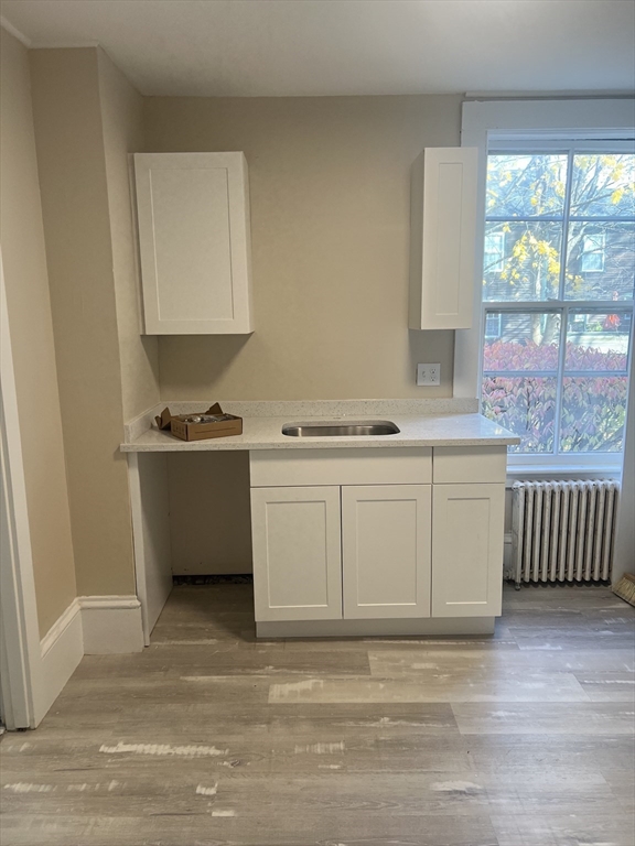 15 Harris Street, Unit 2 Marblehead, MA 01945 - Photo 5 of 19 a view of cabinets a sink and a stove in a room