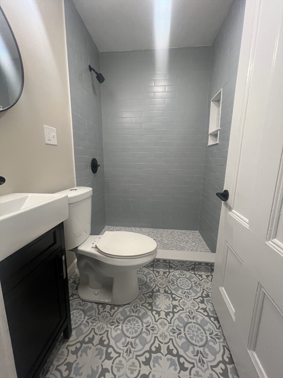 15 Harris Street, Unit 2 Marblehead, MA 01945 - Photo 7 of 19 a white toilet sitting next to a white sink and vanity