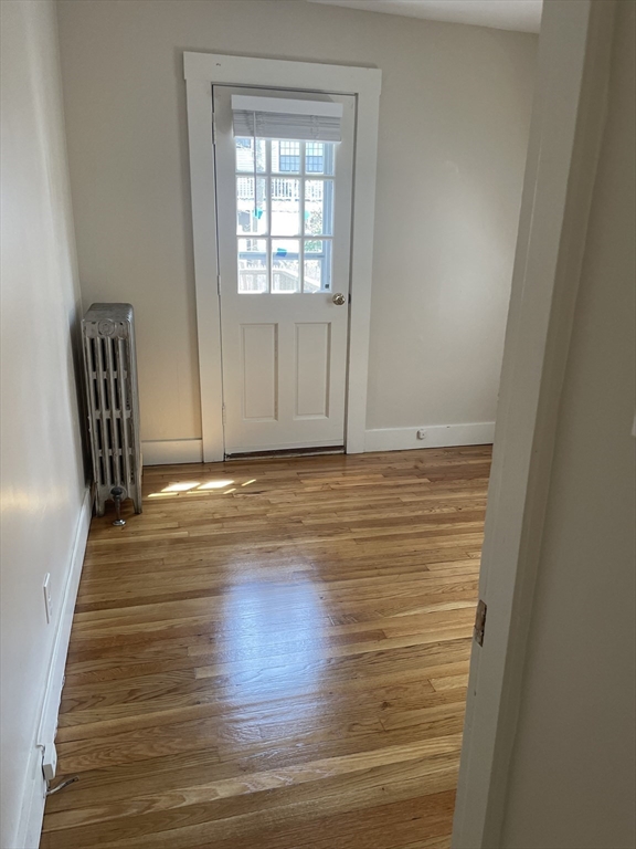 15 Harris Street, Unit 2 Marblehead, MA 01945 - Photo 9 of 19 a view of a livingroom with wooden floor and chair
