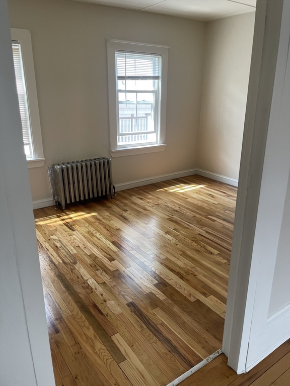 15 Harris Street, Unit 2 Marblehead, MA 01945 - Photo 10 of 19 a view of a room with wooden floor and window