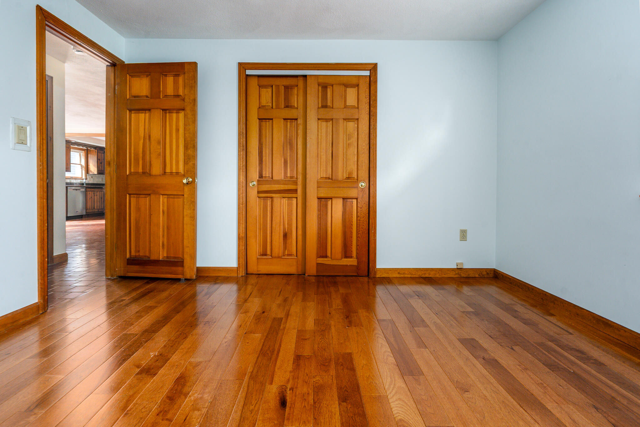 115 Sparrow Hawk Lane Eastham, MA 02642 - Photo 14 of 30 a view of an empty room with wooden floor and a window