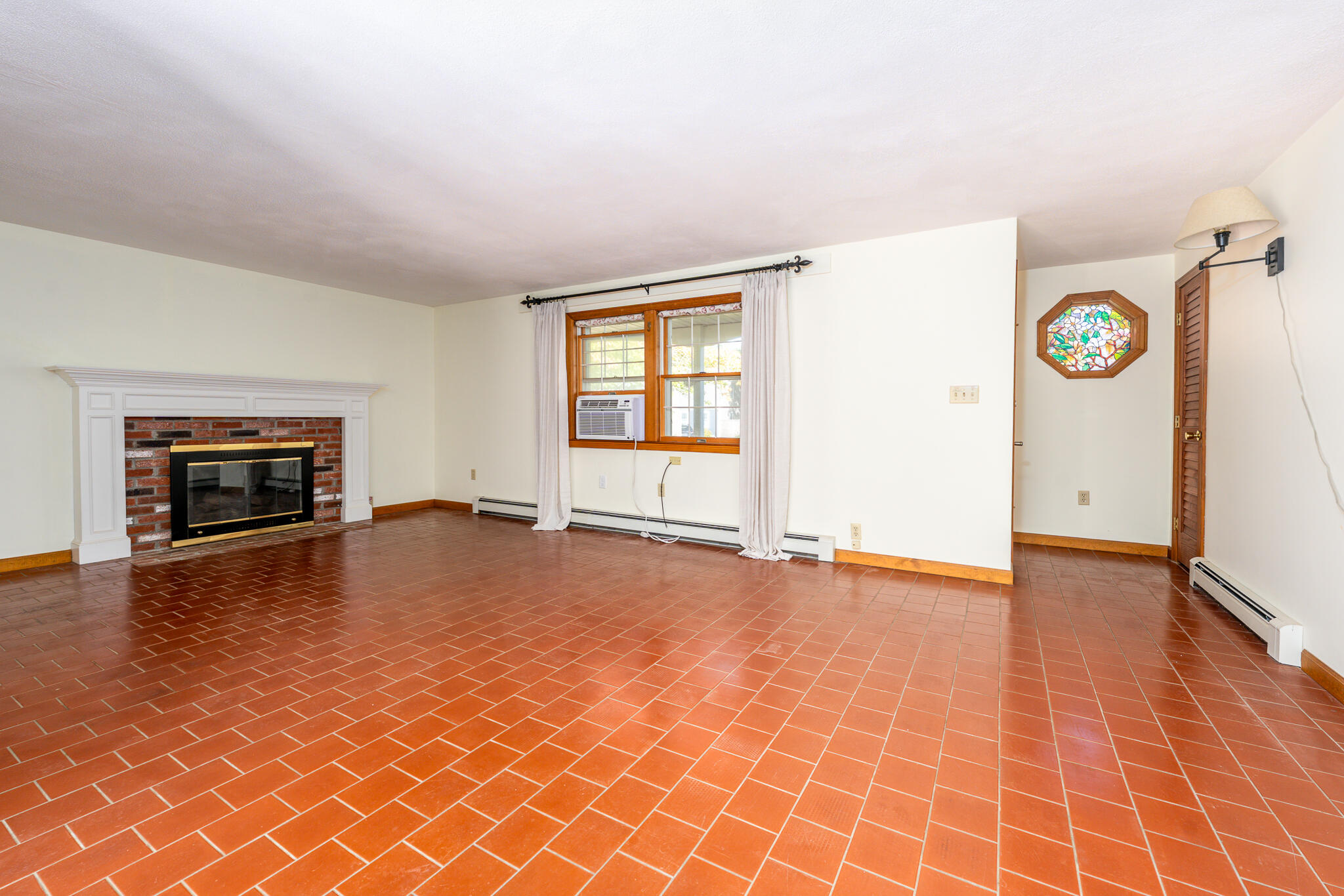 115 Sparrow Hawk Lane Eastham, MA 02642 - Photo 2 of 30 an empty room with windows and fireplace