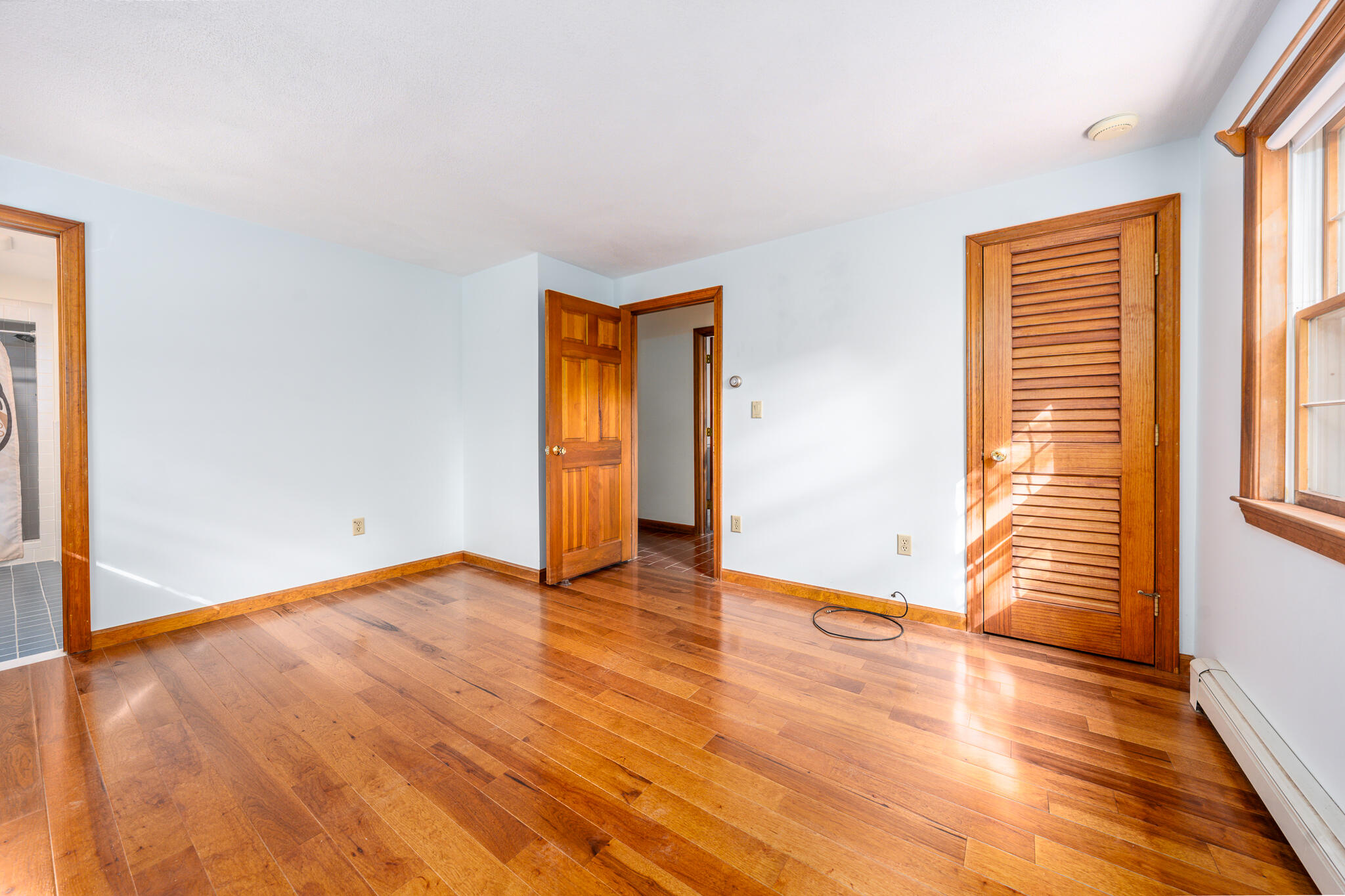 115 Sparrow Hawk Lane Eastham, MA 02642 - Photo 8 of 30 a view of an empty room with wooden floor and a window