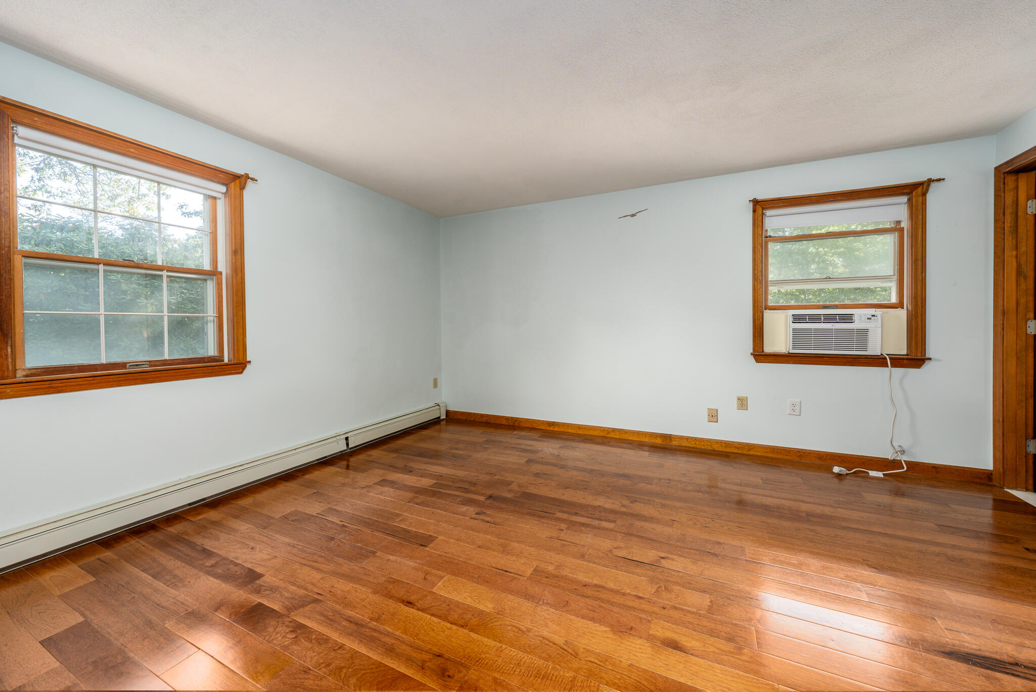 115 Sparrow Hawk Lane Eastham, MA 02642 - Photo 9 of 30 a view of an empty room with wooden floor and a window