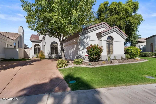 a front view of a house with a garden