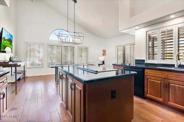 a kitchen with stainless steel appliances granite countertop a stove a sink dishwasher and a refrigerator