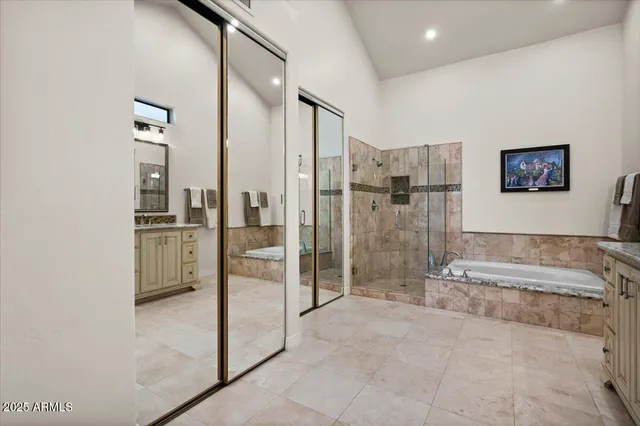 a bathroom with a granite countertop sink a toilet a mirror and shower