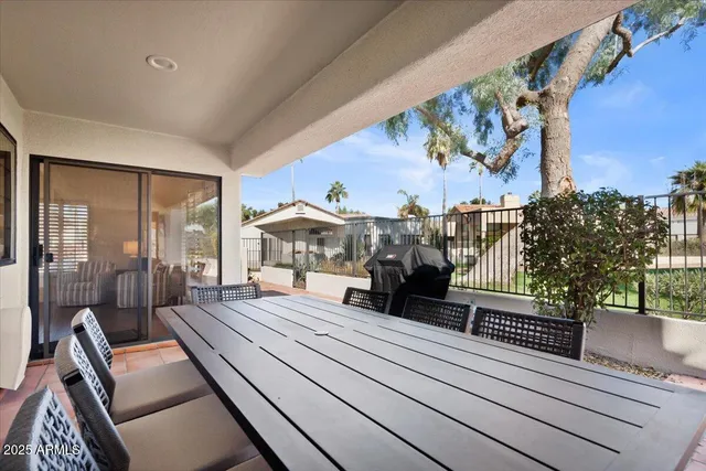 a view of a house with backyard and sitting area