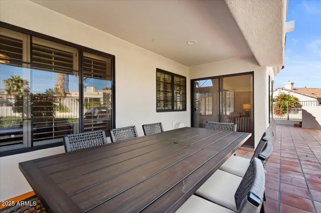 a view of a two chairs and table in the patio