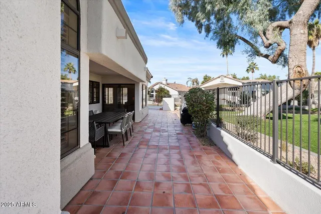 a view of a swimming pool with a patio and a yard