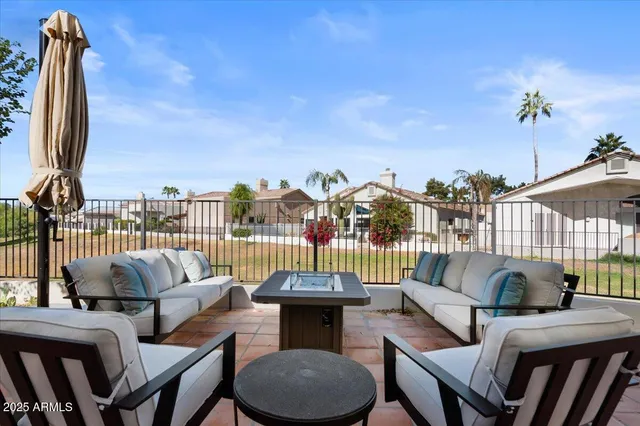 a view of a house with a yard and sitting area