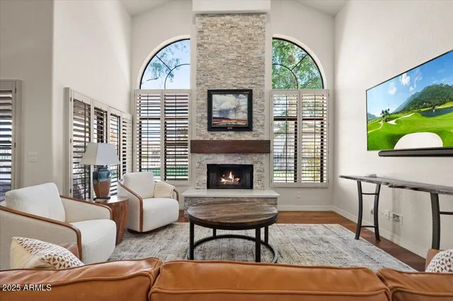 a living room with furniture a fireplace and a flat screen tv