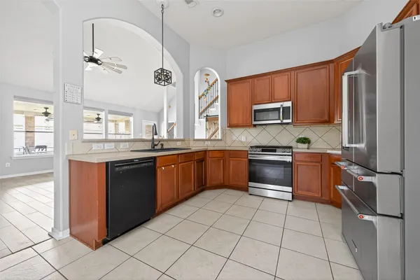 a kitchen with stainless steel appliances a refrigerator sink and cabinets