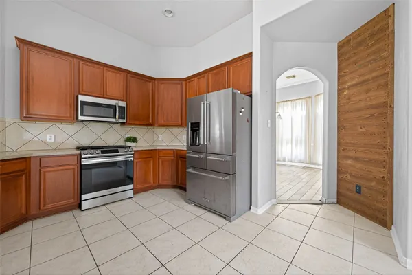 a spacious bathroom with a sink a mirror and a large window