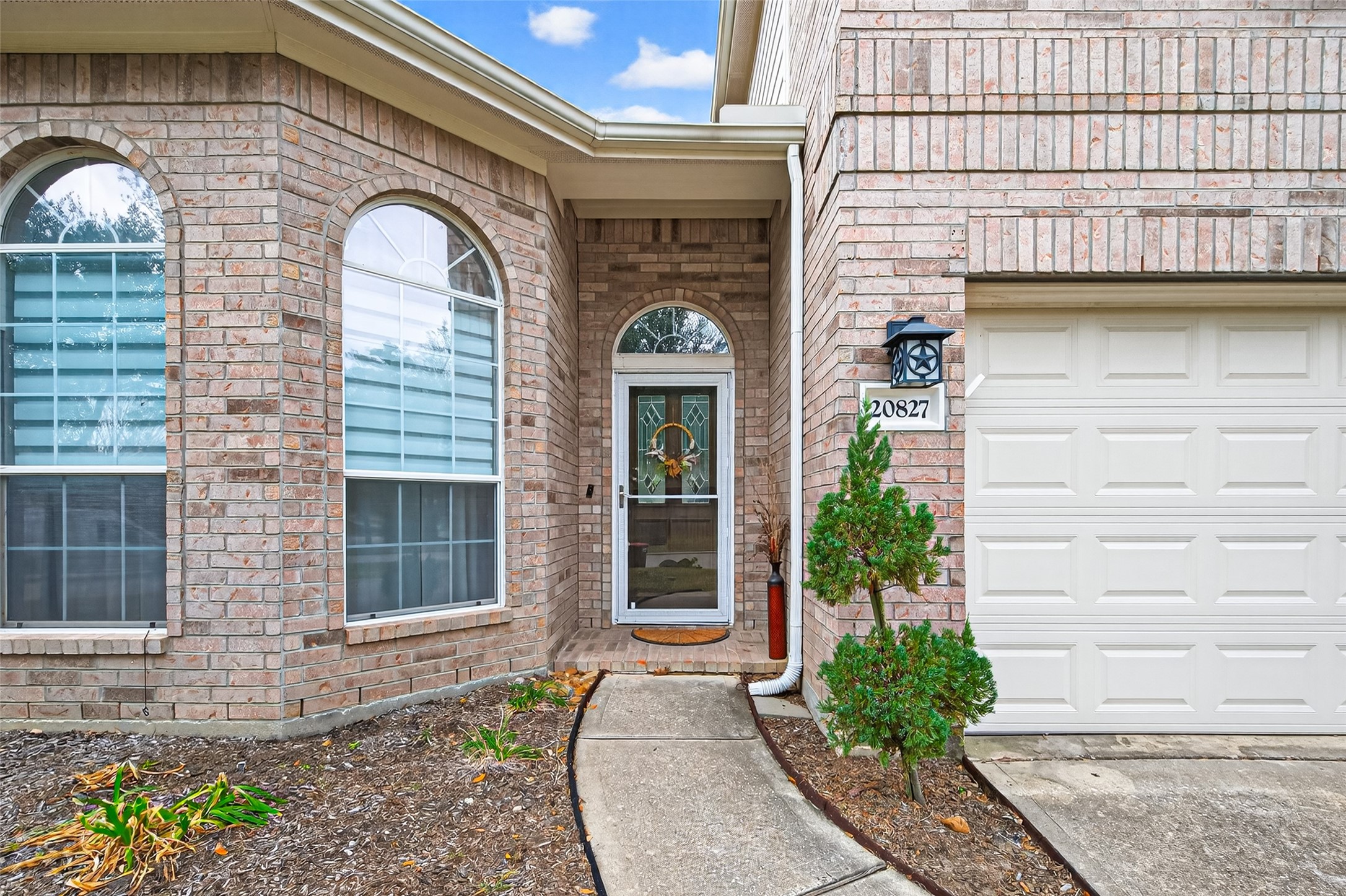 20827 Rose Crossing Lane Spring, TX 77379 - Photo 2 of 50 a front view of a house with a garden