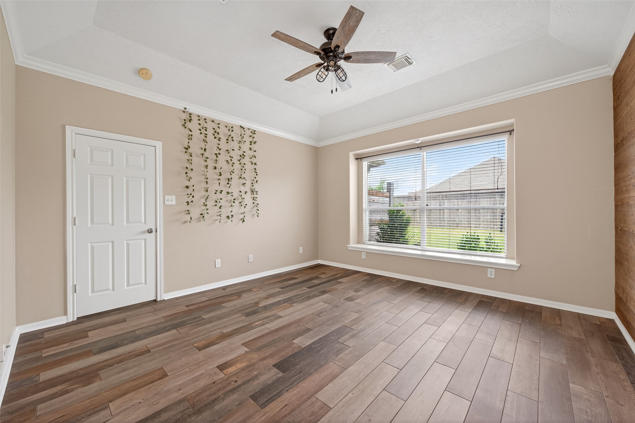 20827 Rose Crossing Lane Spring, TX 77379 - Photo 22 of 50 an empty room with wooden floor chandelier fan and windows