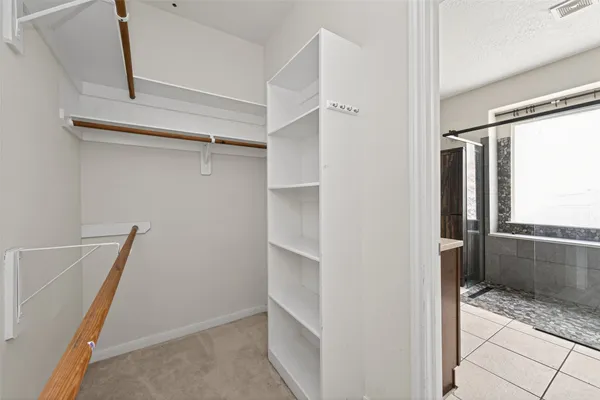 a view of empty room with wooden floor and ceiling fan