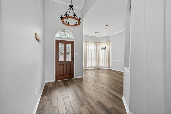 a view of an entryway with wooden floor