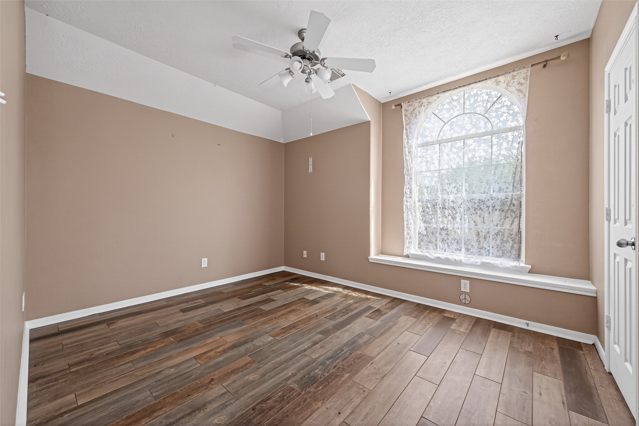 20827 Rose Crossing Lane Spring, TX 77379 - Photo 38 of 50 a view of an empty room with wooden floor and a window