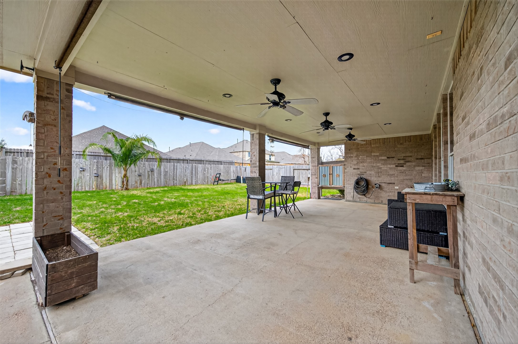 20827 Rose Crossing Lane Spring, TX 77379 - Photo 40 of 50 a view of a patio with a table and chairs next to a yard