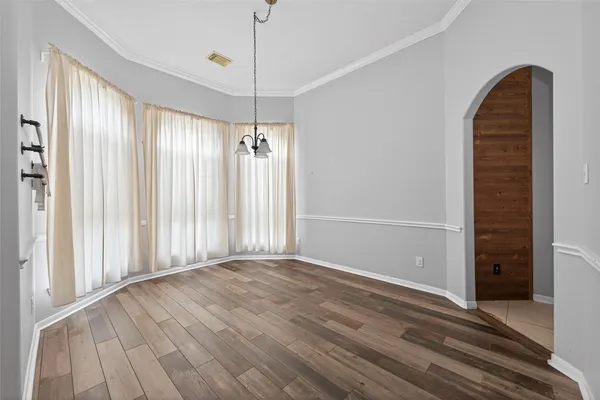a view of a livingroom with wooden floor and a ceiling fan
