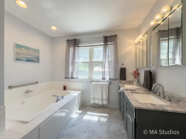 a bathroom with a tub and a shower