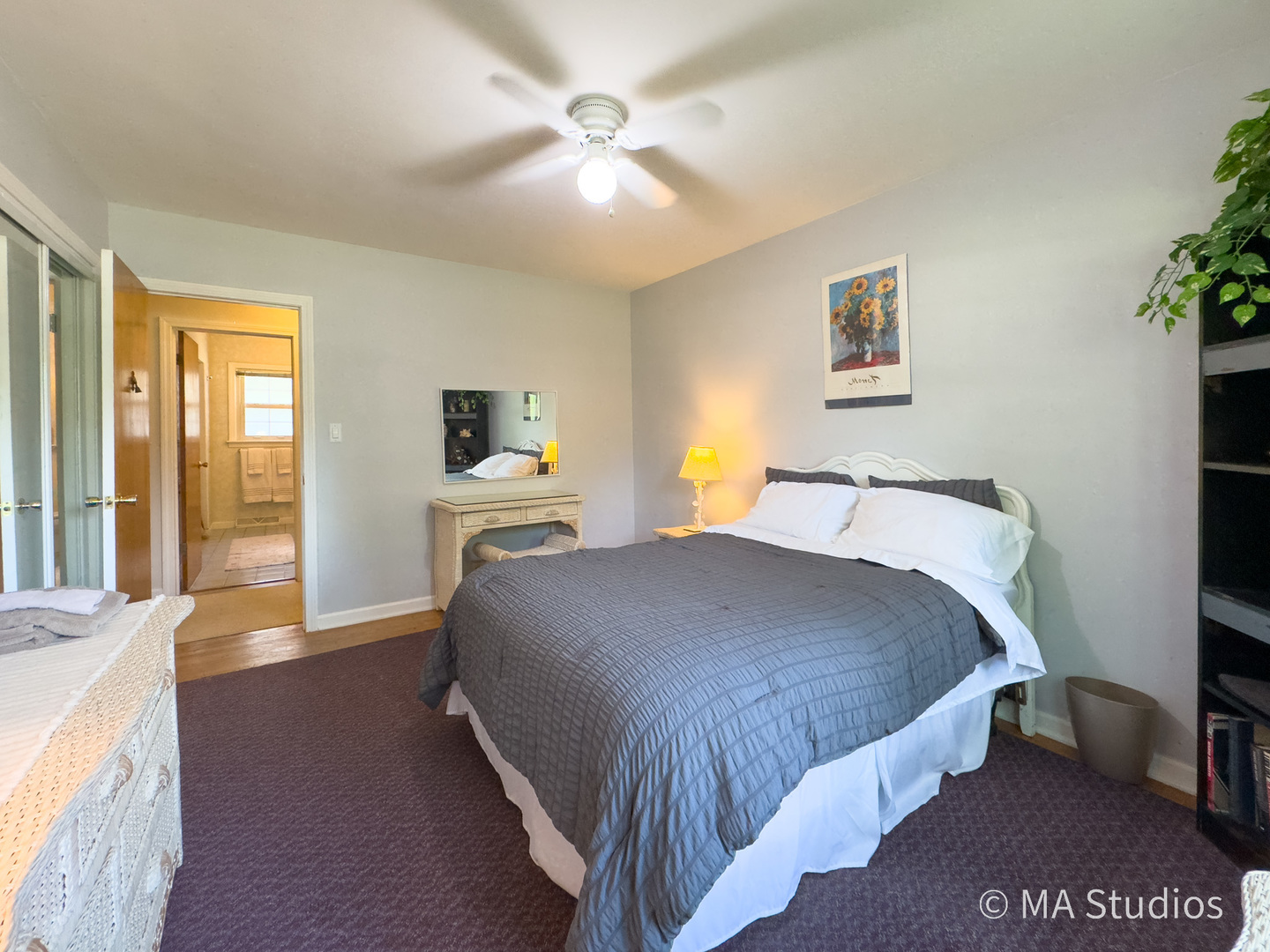 1219 Golf Lane Wheaton, IL 60189 - Photo 19 of 67 a bedroom with a large bed and a chandelier