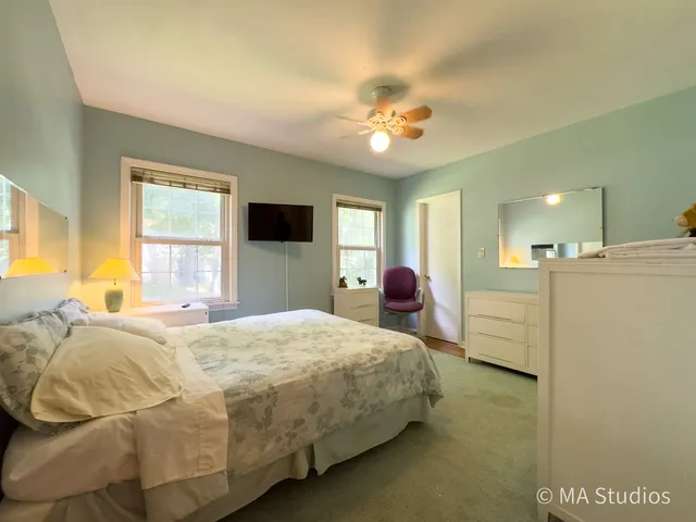 a bathroom with a granite countertop sink a toilet and shower