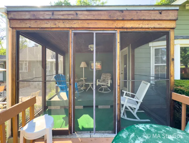 a view of a backyard with large trees and wooden fence